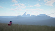 A wide outdoor landscape scene with a person in a red outfit standing in a grassy field, facing distant blue mountains and a pale sky with clouds. No clear sellable product is isolated; this reads as a scenic lifestyle or environmental image rather than a standard product shot.