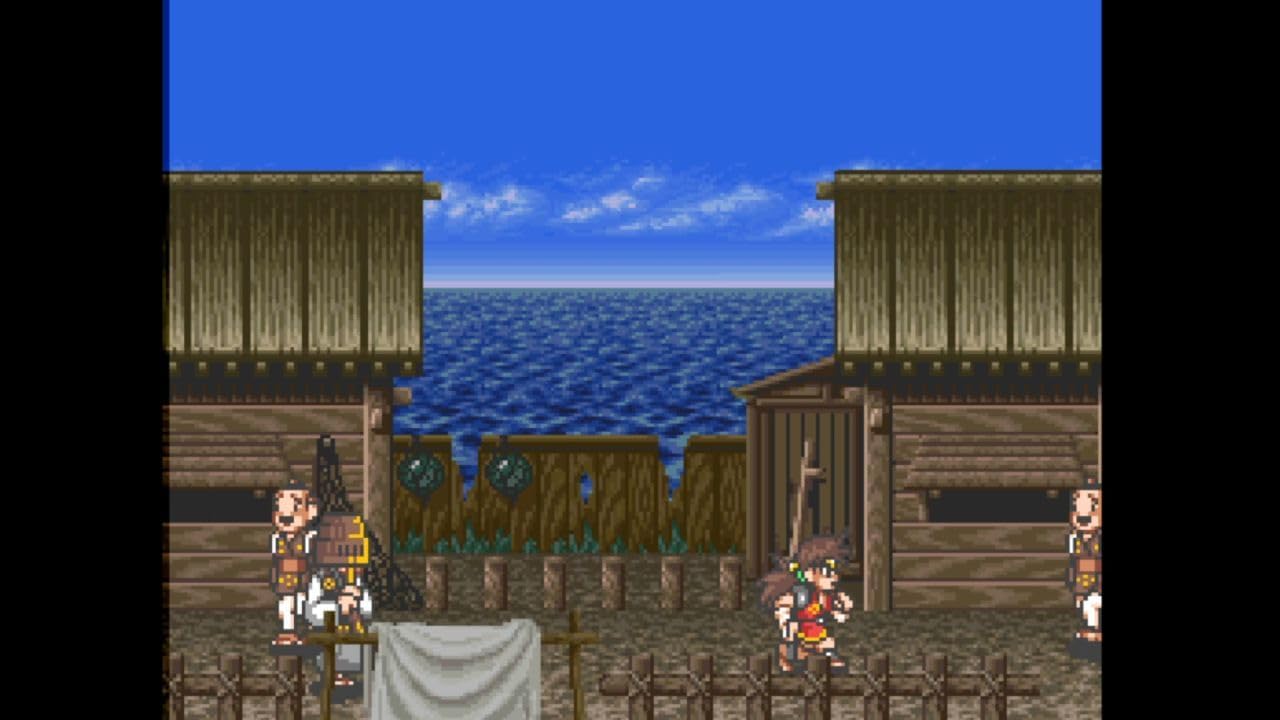 Screenshot of a video game with wooden buildings and ocean view