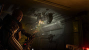 A dark sci-fi scene showing a armored character in the foreground facing multiple Xenomorphs inside a metallic corridor.