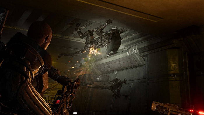 A dark sci-fi scene showing a armored character in the foreground facing multiple Xenomorphs inside a metallic corridor.