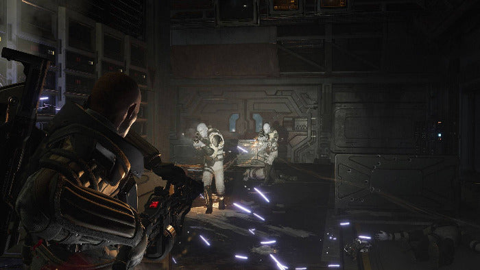 A dark sci-fi scene showing a soldier in armor aiming a rifle in a futuristic industrial interior, with two white-suited figures seated in the background and glowing blue light effects on the floor.