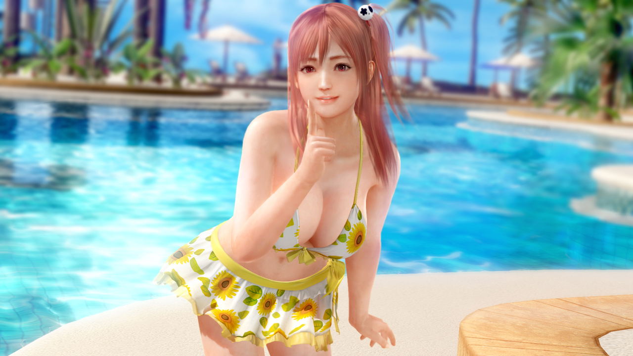 Woman in a yellow bikini with sunflower patterns by a poolside