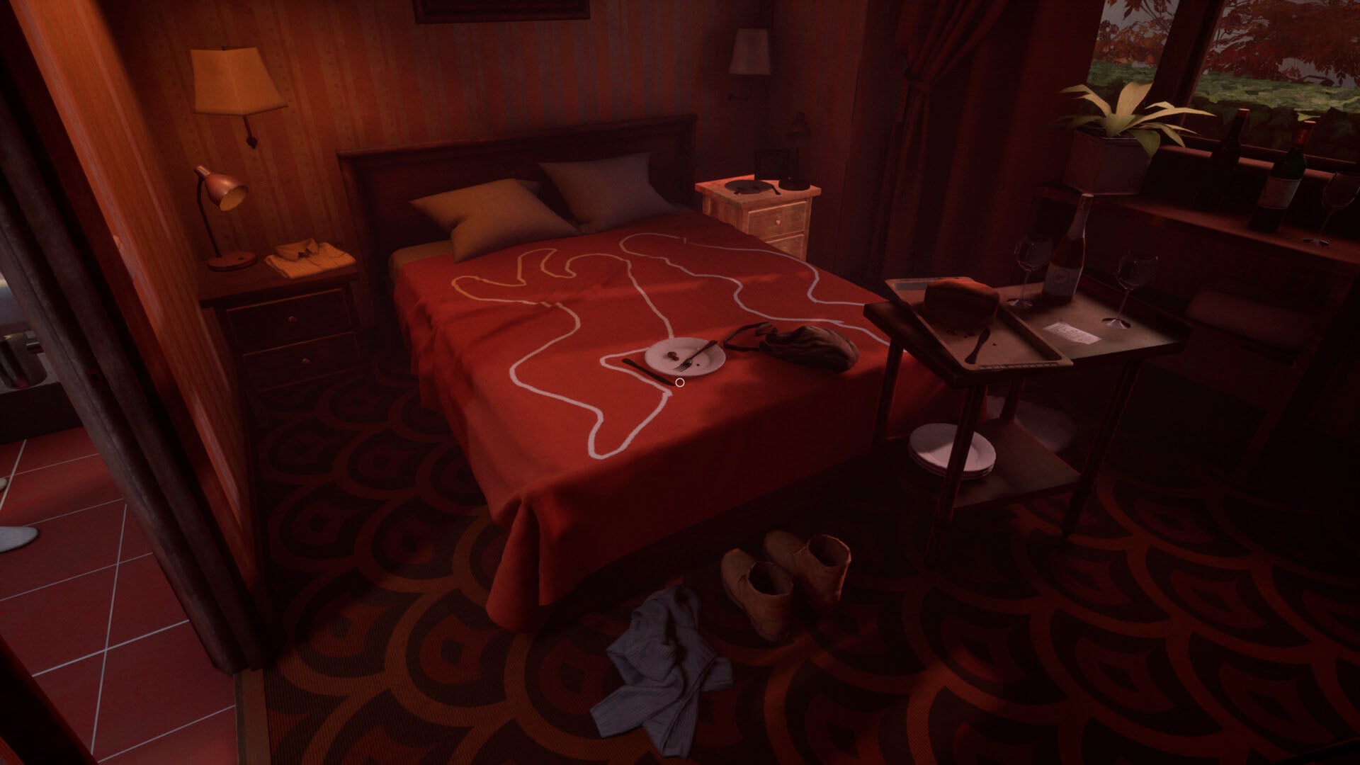 Bedroom with red bedspread, nightstands, and a lamp.
