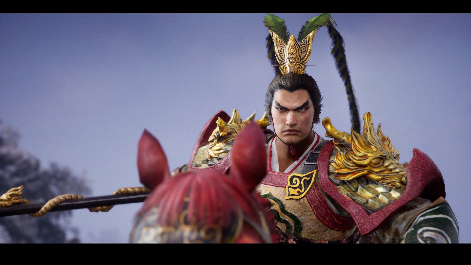 Character in ornate armor with a helmet featuring red plumes against a blue sky.