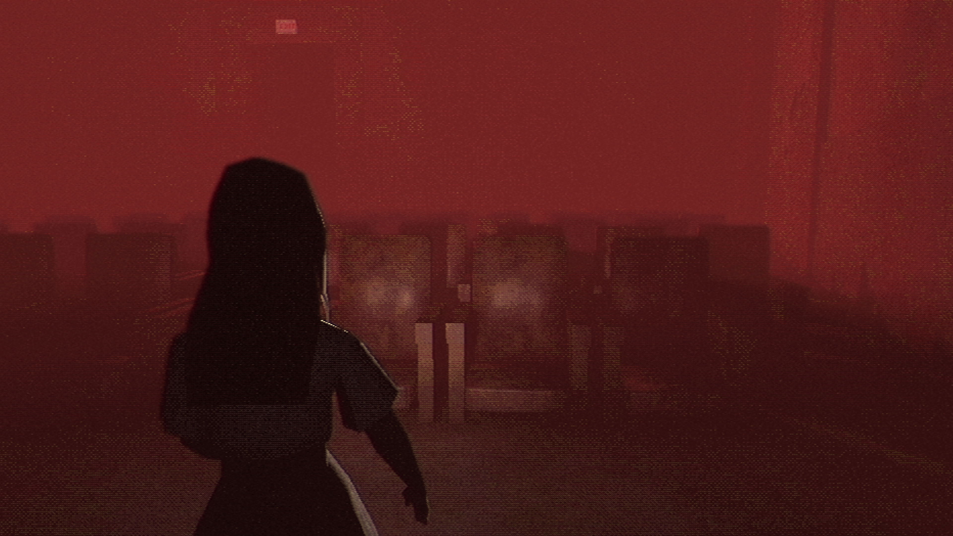 Silhouette of a person in a dark room with a red hue