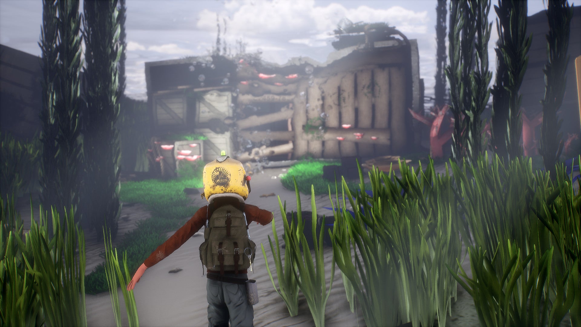 Character in a yellow helmet and backpack walking through a lush, green environment with futuristic buildings in the background.
