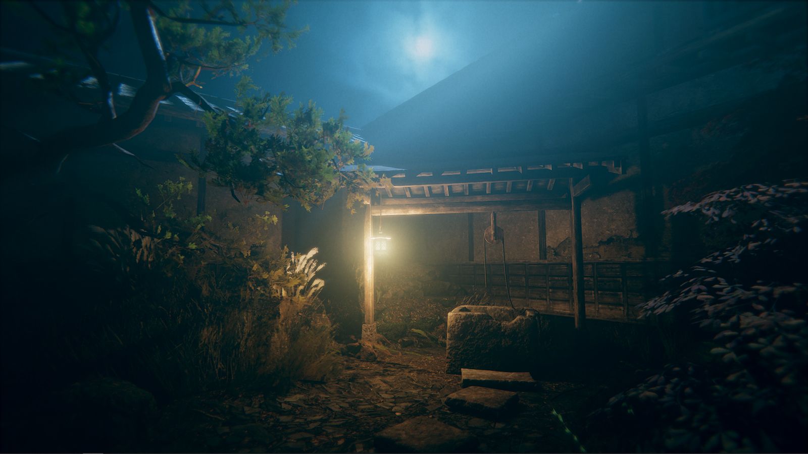 Dark, eerie scene of a wooden structure with a light source at night.