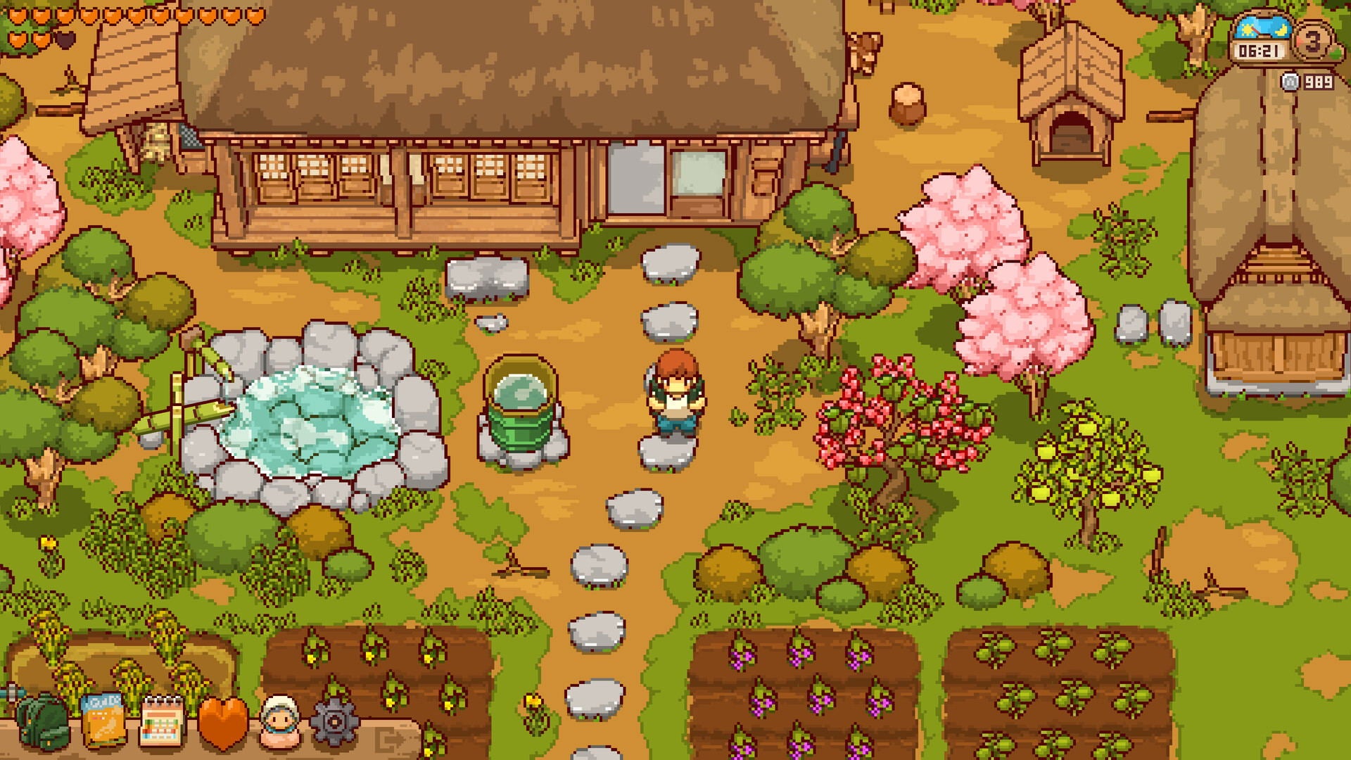 Pixel art illustration of a cozy pixel-style village scene with a wooden house, small cottage, garden beds, trees, pink cherry blossoms, a stone path, and a small character standing near a green bucket.