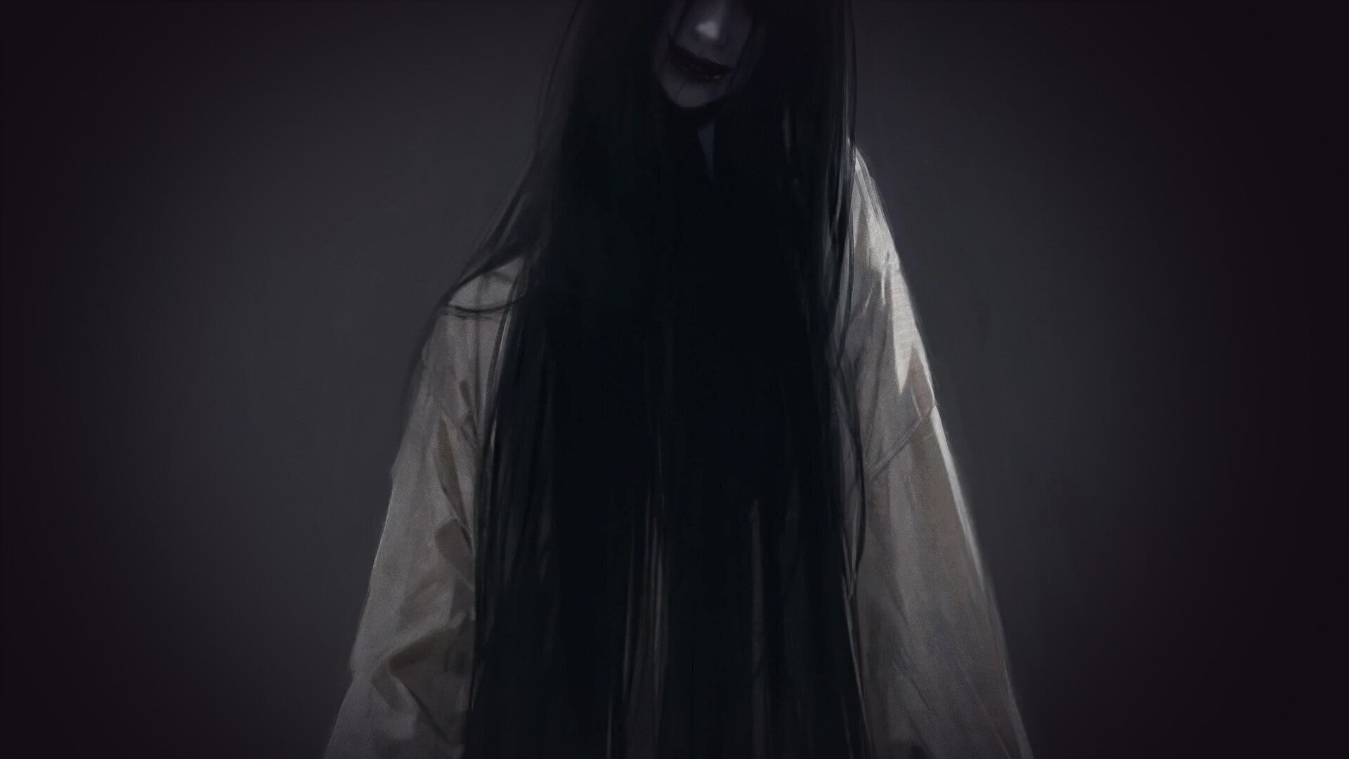 Person wearing a long black hooded garment against a dark background