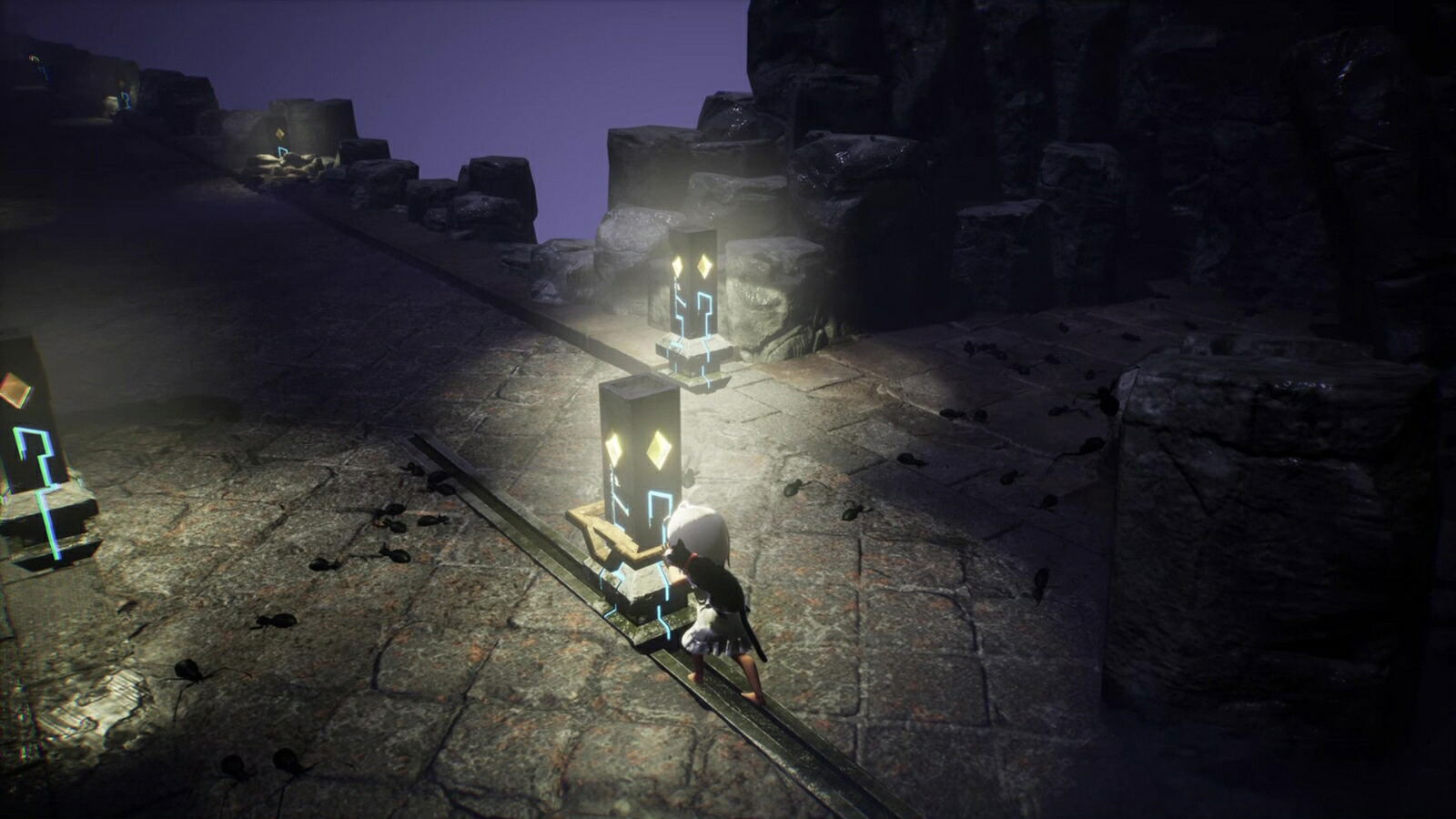 A dark, atmospheric scene showing a small character standing beside glowing rectangular devices on a stone platform, with rocky cliffs and a purple sky in the background.