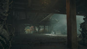 A dark, atmospheric scene inside a traditional wooden structure with a large wooden pillar in the foreground, dusty ground, and a misty outdoor area visible in the distance.