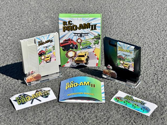 Collection of A.C. Pro-Am II gaming items including cartridge, manual, and packaging on a gray surface.