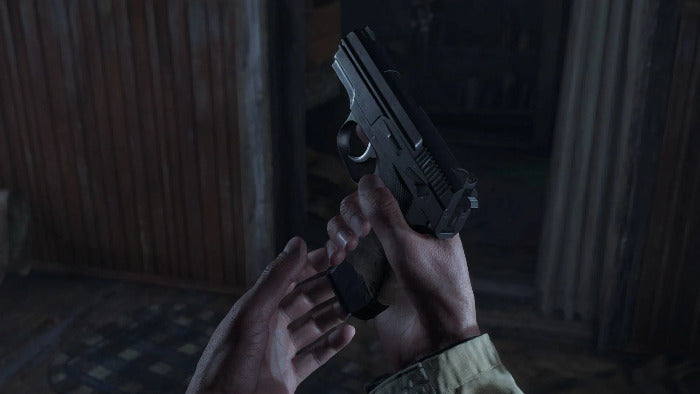 A close-up shot of a person's hands holding a black semi-automatic pistol in a dimly lit, rustic indoor setting.