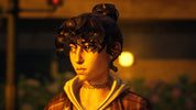 A close-up portrait of a woman with dark curly hair in a bun, wearing a brown plaid jacket over a beige hoodie and a black choker necklace, set against a warm, dimly lit background.