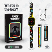Space Invaders themed watch with packaging, charging cable, and alternate band on a light gray background.