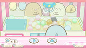 A pastel-colored claw machine game screen featuring cute cartoon characters inside a pink machine with pastel balls and control buttons at the bottom.