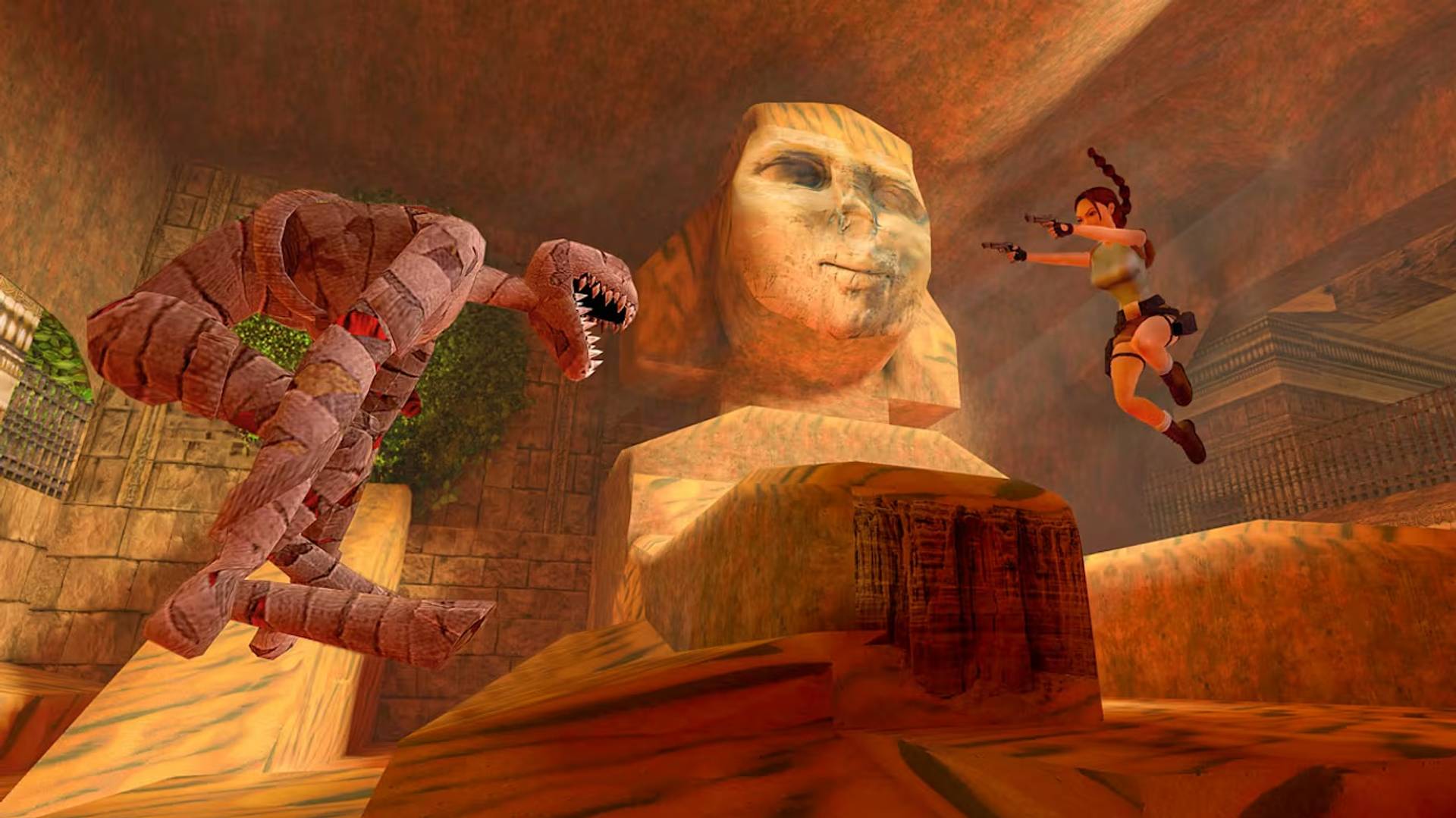 Video game scene with a character leaping over a mummy towards a sphinx.