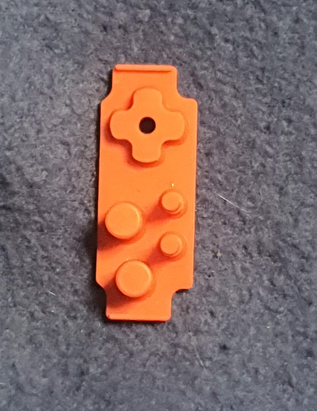 Orange building block on a gray surface