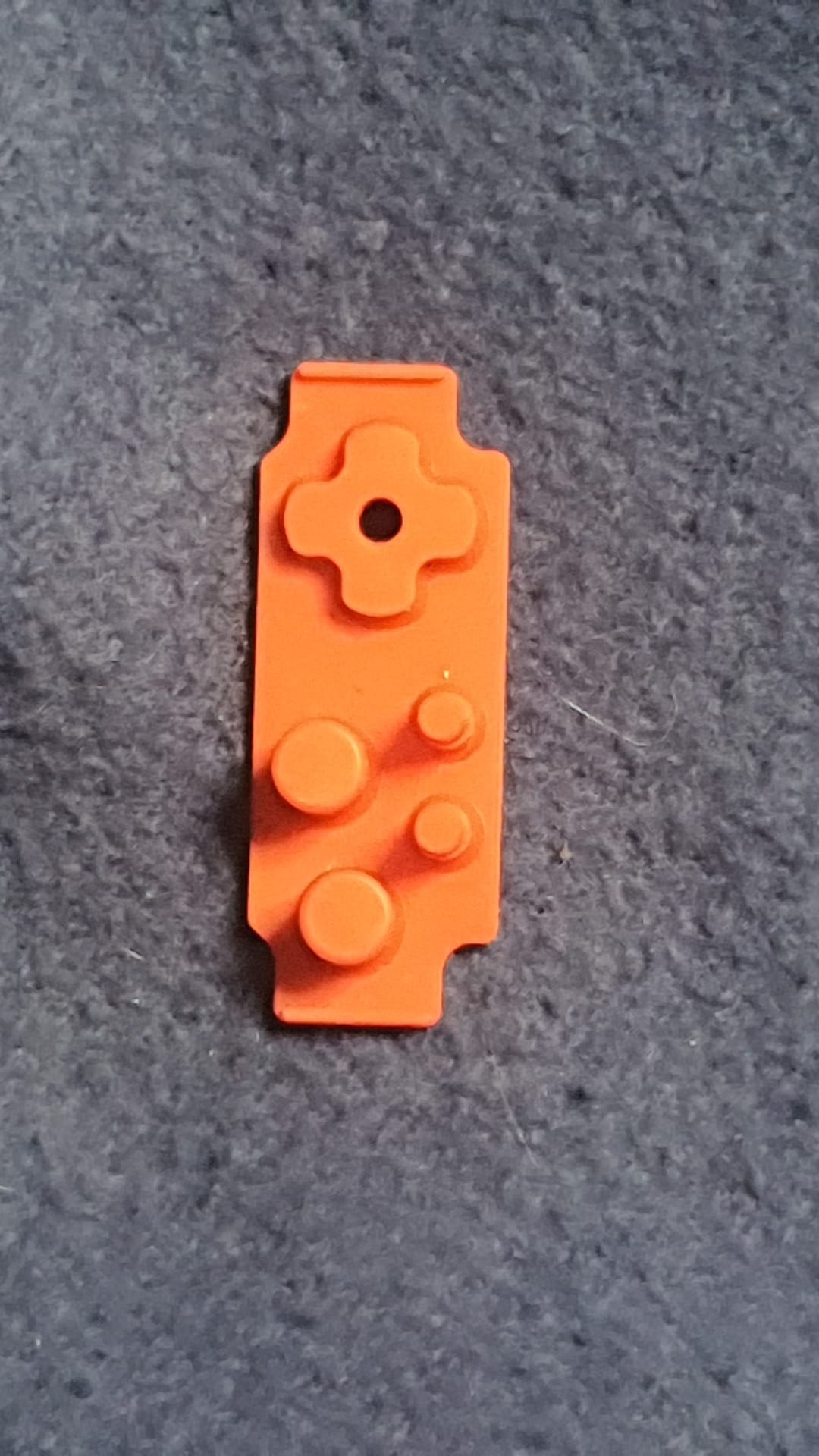 Orange building block on a gray surface